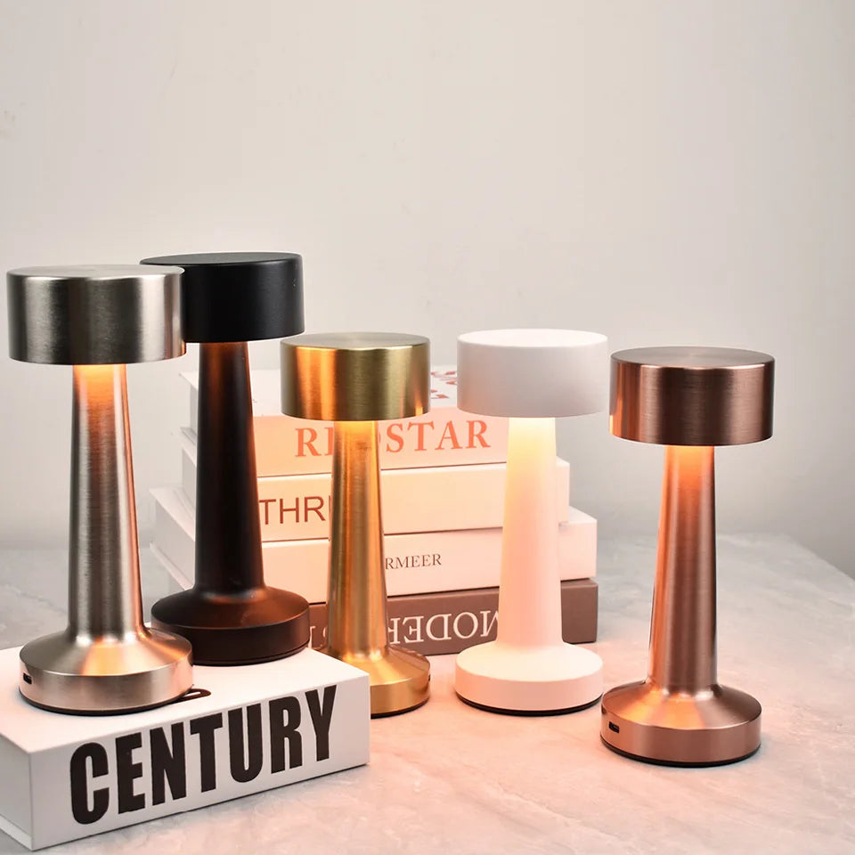 Set of five table lamps with different finishes on a neutral background
